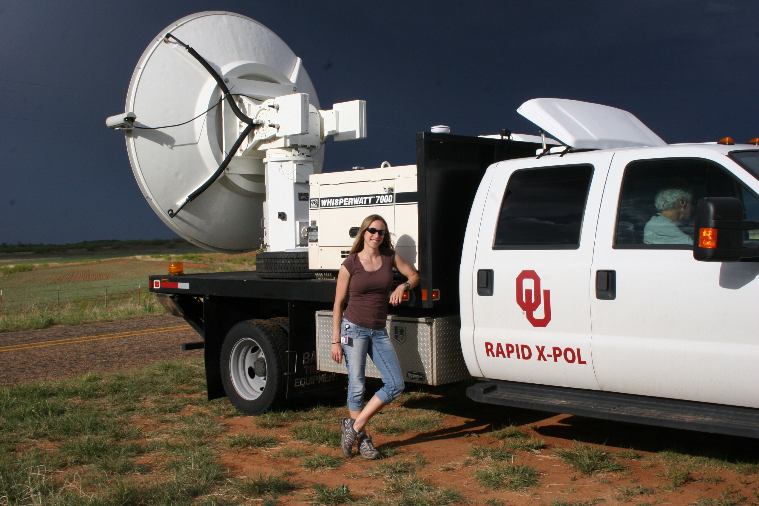 Jana Houser standing next to the RaXPol radar during a storm chase on 8 May 2012.  Credit: Jana Houser.