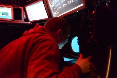Here’s Adam Soule in the pilot’s seat of Alvin, taking a turn at driving the sub - it’s harder than it looks! Credit: Woods Hole Oceanographic Institution.